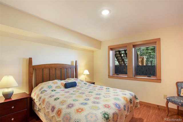 bedroom with hardwood / wood-style flooring