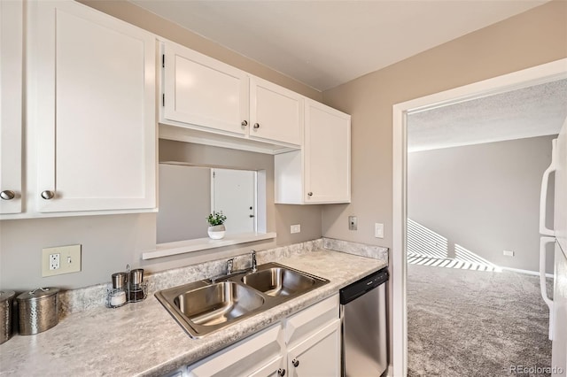 kitchen featuring carpet flooring, white cabinets, stainless steel dishwasher, and sink