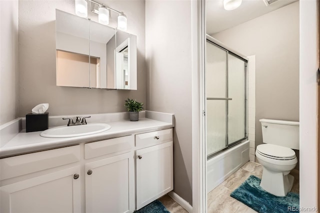 full bathroom with vanity, enclosed tub / shower combo, and toilet