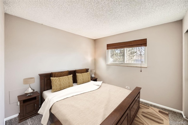 carpeted bedroom with a textured ceiling