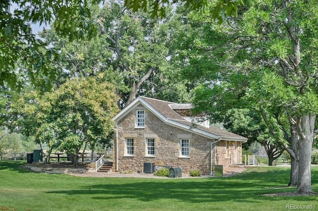 back of house with a yard and cooling unit