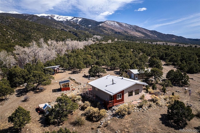 125 Deer Run, Mosca, CO 81146 - view of subject property featuring a mountain backdrop and a heavily wooded area