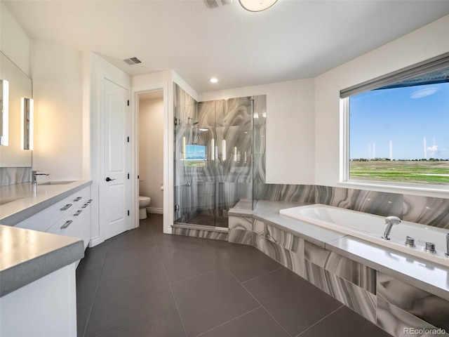 full bathroom featuring vanity, independent shower and bath, toilet, and tile patterned floors