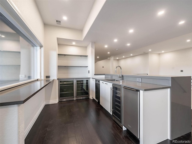 kitchen featuring sink, kitchen peninsula, stainless steel fridge, dark wood-type flooring, and wine cooler