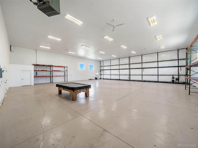 garage featuring ceiling fan and a garage door opener