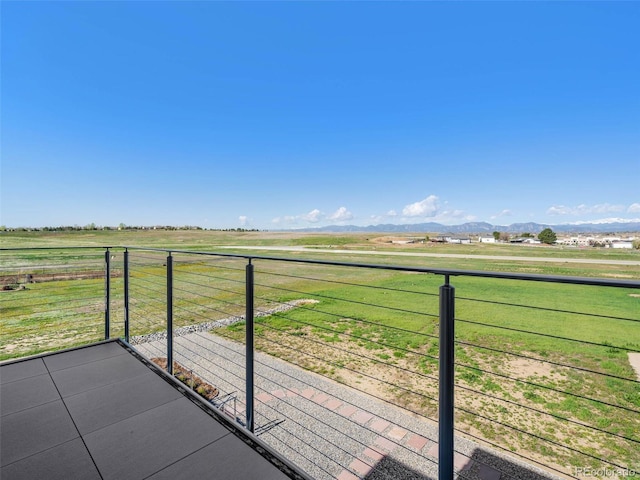 balcony featuring a mountain view and a rural view