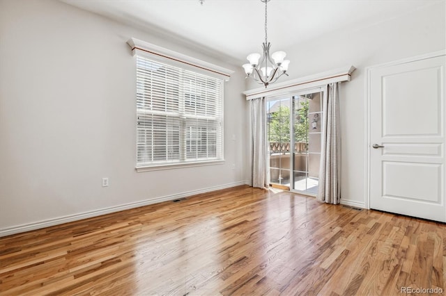 11972 W Long Cir Unit 104, Littleton, CO 80127 - unfurnished dining area featuring a chandelier and light wood-type flooring
