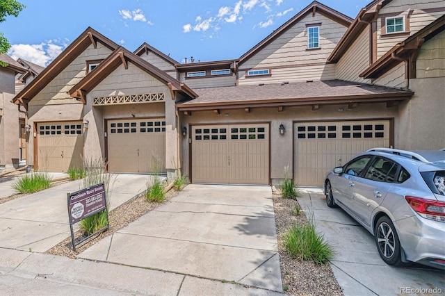 11972 W Long Cir Unit 104, Littleton, CO 80127 - townhome / multi-family property with driveway and stucco siding