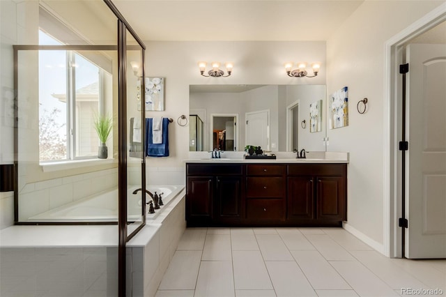 10653 E 163rd Ct, Brighton, CO 80602 - full bathroom with a garden tub, double vanity, tile patterned floors, and baseboards