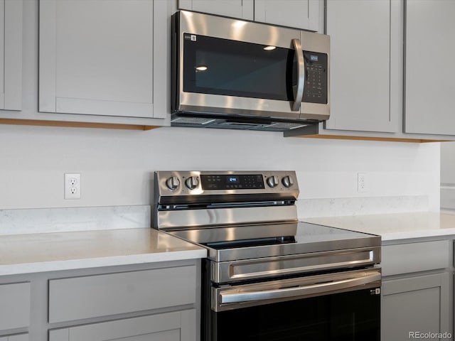 kitchen with gray cabinetry and stainless steel appliances