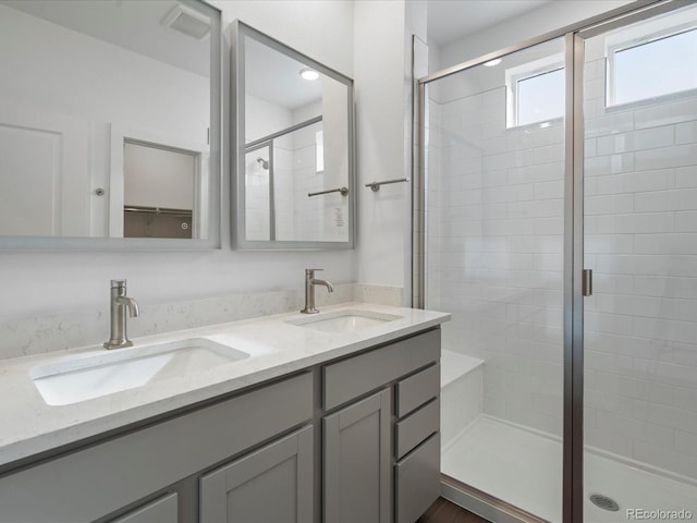 bathroom with walk in shower and vanity