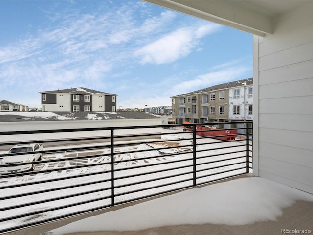 view of snow covered back of property