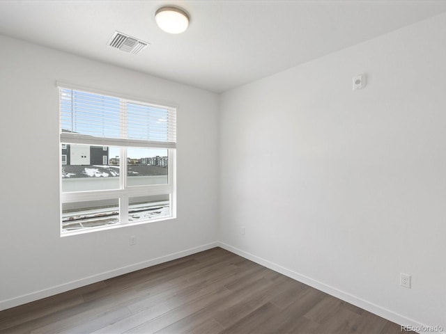 unfurnished room featuring dark hardwood / wood-style flooring