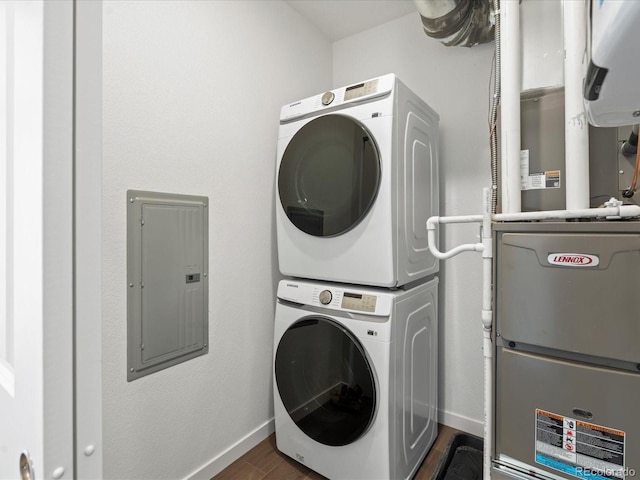 laundry area featuring stacked washer and dryer, electric panel, and dark hardwood / wood-style flooring