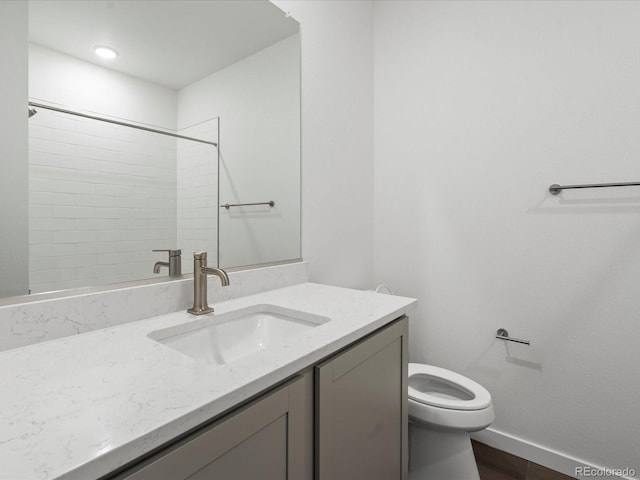 bathroom featuring vanity, toilet, and hardwood / wood-style floors