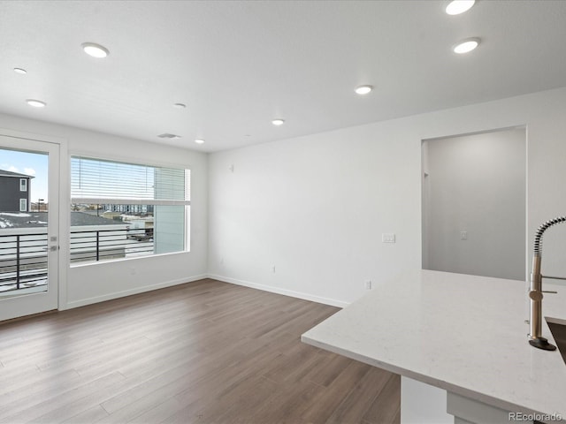 unfurnished living room with hardwood / wood-style flooring