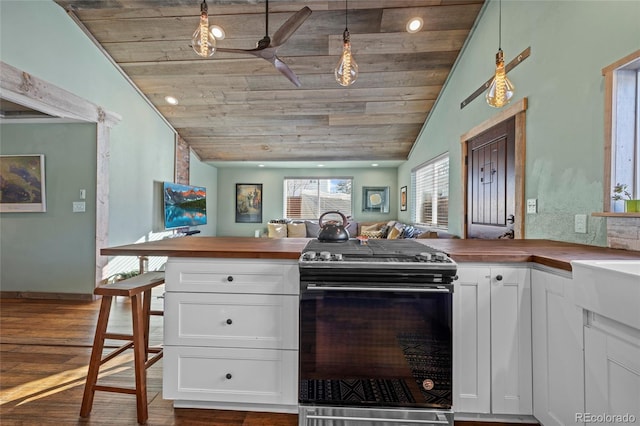 kitchen with vaulted ceiling, wood ceiling, range with electric stovetop, and butcher block counters