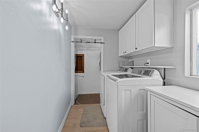 washroom featuring cabinet space, separate washer and dryer, baseboards, and light tile patterned floors