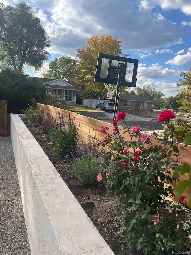 view of basketball court featuring fence