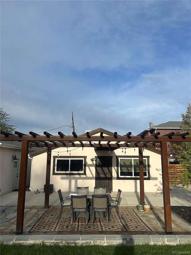 view of patio featuring a pergola and outdoor dining area