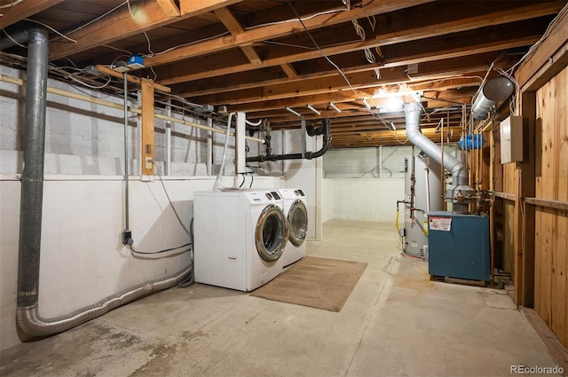 washroom with washer and dryer and a heating unit