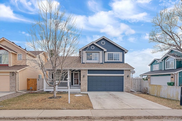 traditional-style home with covered porch, brick siding, fence, and driveway