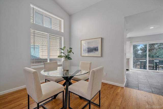 dining area featuring a wealth of natural light, baseboards, and wood finished floors