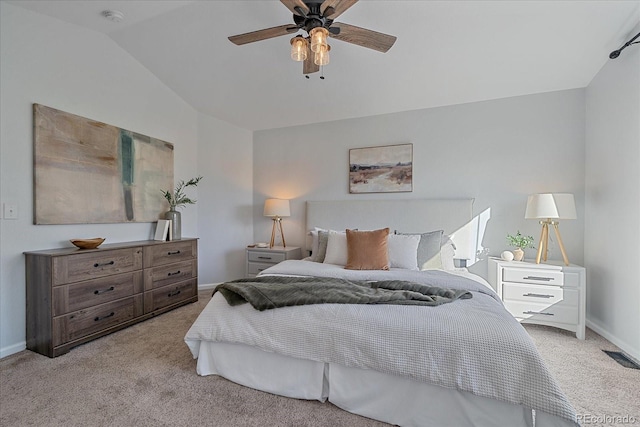 bedroom with lofted ceiling, light colored carpet, visible vents, and baseboards