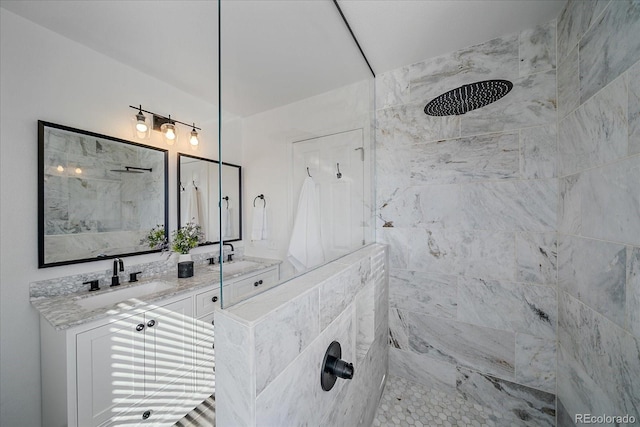 full bath with a tile shower and vanity