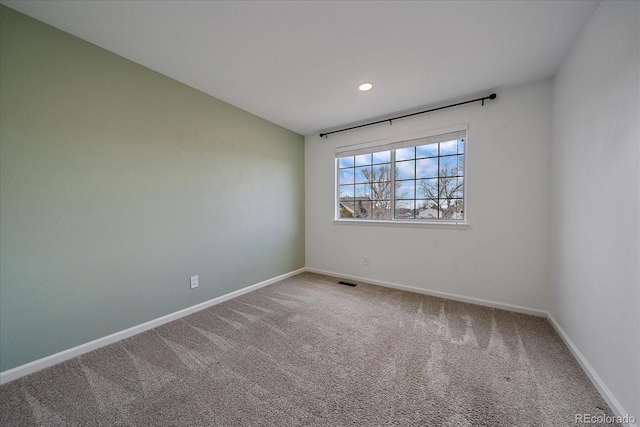 carpeted empty room featuring recessed lighting, visible vents, and baseboards