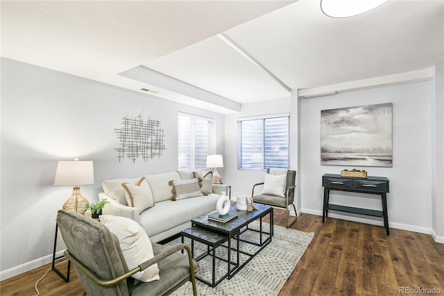 living area featuring visible vents, baseboards, and wood finished floors