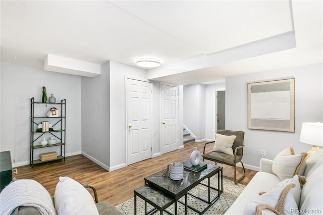 living area featuring stairway, wood finished floors, and baseboards