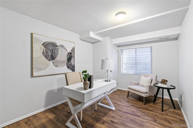 office space with visible vents, baseboards, and wood finished floors