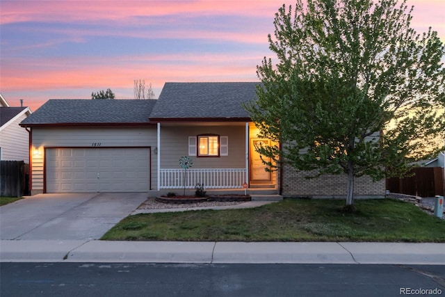 1511 S Cora Ave, Milliken, CO 80543 - view of front of property featuring a porch, a garage, concrete driveway, and roof with shingles