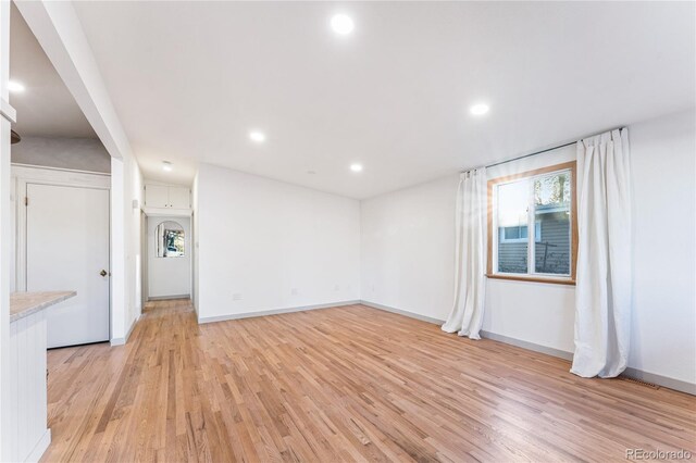 8120 W 54th Pl, Arvada, CO 80002 - unfurnished room with light wood-style flooring, healthy amount of natural light, recessed lighting, and baseboards