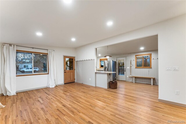 8120 W 54th Pl, Arvada, CO 80002 - unfurnished living room with light wood-type flooring, recessed lighting, and baseboards