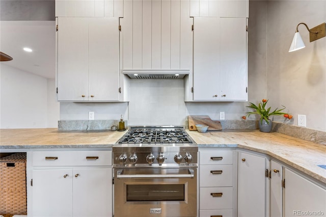 8120 W 54th Pl, Arvada, CO 80002 - kitchen featuring high end stainless steel range oven, light countertops, tasteful backsplash, white cabinets, and under cabinet range hood
