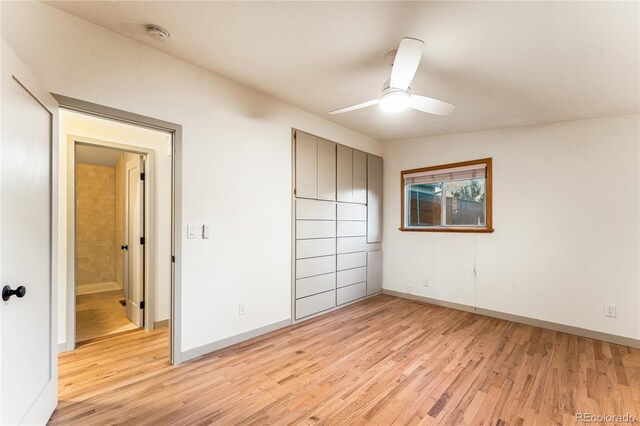 8120 W 54th Pl, Arvada, CO 80002 - unfurnished bedroom featuring light wood-type flooring, baseboards, and a ceiling fan