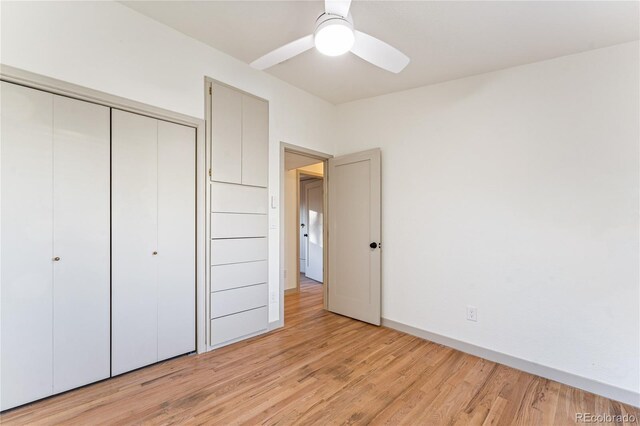 8120 W 54th Pl, Arvada, CO 80002 - unfurnished bedroom featuring a closet, light wood finished floors, baseboards, and ceiling fan