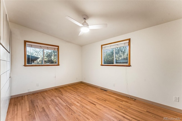 8120 W 54th Pl, Arvada, CO 80002 - empty room with plenty of natural light, light wood-style floors, ceiling fan, baseboards, and vaulted ceiling