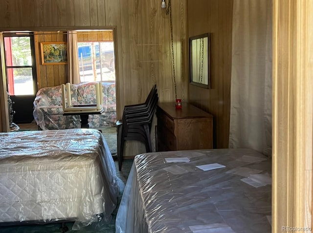 bedroom featuring wood walls