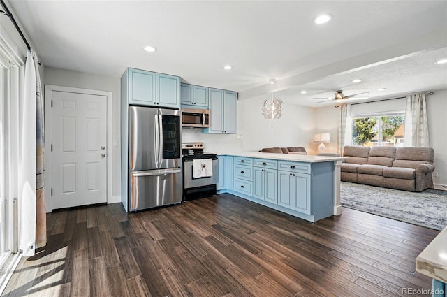 6655 S Elm Cir, Centennial, CO 80121 - kitchen featuring stainless steel appliances, a peninsula, blue cabinets, dark wood-style flooring, and recessed lighting