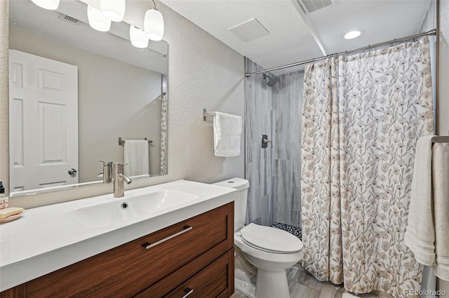 6655 S Elm Cir, Centennial, CO 80121 - bathroom featuring toilet, vanity, curtained shower, a textured wall, and recessed lighting