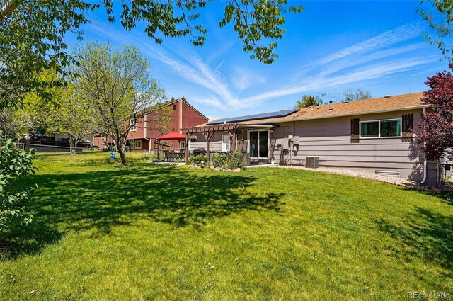 6655 S Elm Cir, Centennial, CO 80121 - rear view of property with roof mounted solar panels and central AC