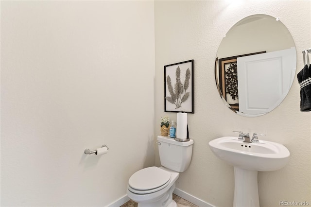 bathroom featuring toilet and sink