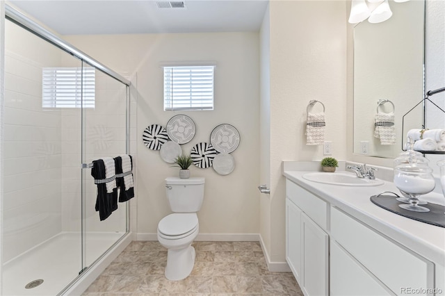 bathroom with toilet, a shower with door, and vanity