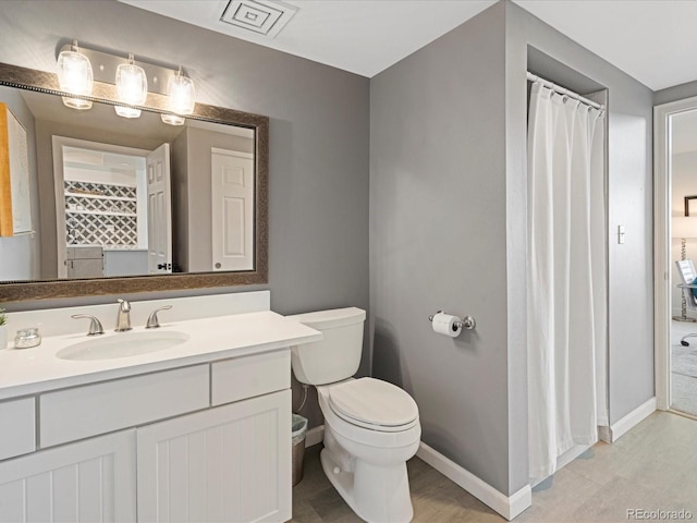 bathroom featuring hardwood / wood-style floors, vanity, and toilet