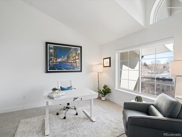 carpeted office space with vaulted ceiling