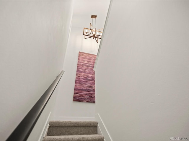 stairs with a chandelier