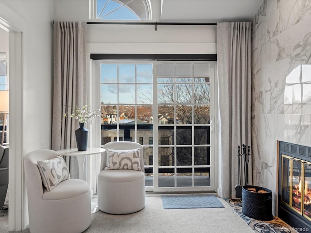 sitting room featuring a glass covered fireplace